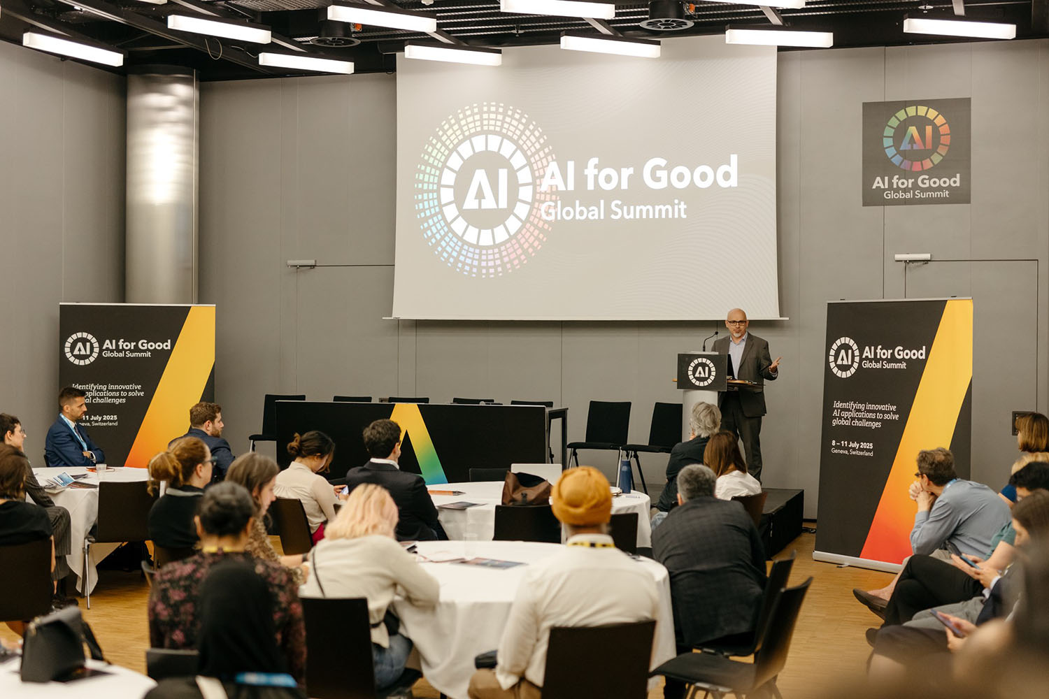 Diplo/GIP at AI for Good Global Summit 10 People, Person, Crowd, Adult, Female, Woman, Audience, Male, Man, Architecture, Building, Indoors, Lecture, Classroom, Room, School, Hall, Face, Head, Accessories, Bag, Handbag, Speech, James Mayhew, Allison Weiss, Dan Mangan