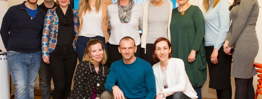 Our story 9 Groupshot, Person, People, Clothing, Jeans, Pants, Adult, Female, Woman, Coat, Male, Man, Footwear, Shoe, Face, Head, Computer Hardware, Electronics, Hardware, Monitor, Screen, Jennifer Damiano