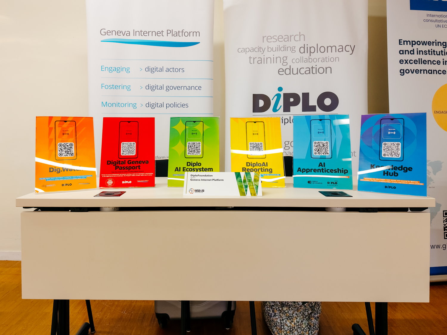 Diplo/GIP at the WSIS+20 High-Level Event 2025 3 Advertisement, Poster, Furniture, Table, Desk, QR Code